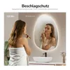 A woman is applying makeup in front of a lighted mirror in a bathroom. Náhľad obrázku produktu