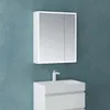 A white medicine cabinet with LED lighting is mounted on a blue textured wall above a white sink and vanity. Produktbild-Vorschau