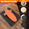 A balance board with a cork roller on a dark gray mat, placed on a wooden floor. The image includes close-up insets highlighting product features. Produktbild-Vorschau