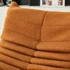 A close-up view of an orange textured cushion or pillow. Voir les images du produit
