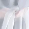 A person's hands holding and draping white sheer fabric. Produktbild-Vorschau