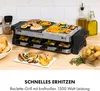 A raclette grill with food on it, set on a wooden countertop with kitchen items in the background. Produktbild-Vorschau