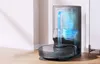 A robot vacuum cleaner docked in its charging station, with a visual representation of the dust collection process inside the station. Náhľad obrázku produktu