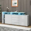 A white sideboard with LED lighting is displayed in a room with a wooden wall and a patterned rug. Voir les images du produit