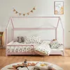 A child's bed with bedding and stuffed animals in a room. Anteprima dell’immagine prodotto