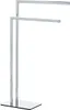 A freestanding towel rack with two arms, made of polished metal, shown against a white background. Náhled obrázku produktu