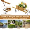 A collage of images showing a wooden wheelbarrow planter with flowers, close-ups of its features, and various outdoor settings like a terrace, backyard, garden, and balcony. Podgląd zdjęcia produktu
