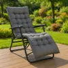 A gray padded recliner chair is placed on a wooden deck in a garden setting. Náhľad obrázku produktu