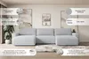 A light gray sectional sofa with chaise lounges is shown in a well-lit living room setting, with abstract art on the wall and a potted plant. Text overlays highlight features of the sofa. Produktbild-Vorschau