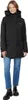 A woman wearing a black parka and blue jeans, standing against a white background. Produktbild-Vorschau