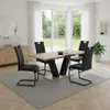 A dining room set with a table and chairs, set in a well-lit room with large windows overlooking a garden. Produktbild-Vorschau