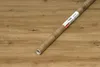 A roll of wood-effect adhesive foil lies on a wooden surface. Náhled obrázku produktu