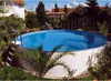 An above-ground swimming pool in a backyard setting. Produktbild-Vorschau