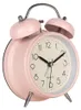 A pink analog alarm clock with silver accents is shown against a white background. Voir les images du produit