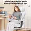A woman is sitting in a white gaming chair and reading a magazine. Náhľad obrázku produktu