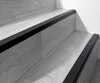 Close-up view of stair treads with black anti-slip profiles. Anteprima dell’immagine prodotto
