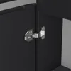 A close-up view of a cabinet hinge on a black cabinet door. Anteprima dell’immagine prodotto
