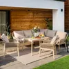 A patio furniture set is arranged on a tiled patio area, with a wooden wall in the background and grass in the foreground. Náhľad obrázku produktu