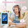 A young girl wearing headphones is happily listening to music from a blue toy smartphone. Produktbild-Vorschau