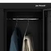 Interior view of a black metal locker with two garments hanging on hangers. Voir les images du produit