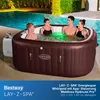 People relaxing in an inflatable hot tub next to a swimming pool. Produktbild-Vorschau