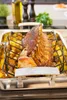 A roasted rack of lamb with potatoes in a roasting pan. Produktbild-Vorschau