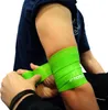 A person's arm with a green flossband being applied. Produktbild-Vorschau
