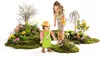 A young girl and a Playmobil figure are in a garden setting with flowers and moss. Podgląd zdjęcia produktu