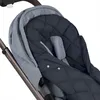 A close-up view of a navy blue quilted stroller footmuff with gray accents, attached to a stroller frame. Produktbild-Vorschau