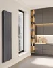 A modern kitchen with dark cabinets and a tall, black radiator next to a window. Produktbild-Vorschau