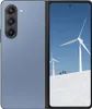A blue foldable smartphone is shown open, displaying a winter landscape with wind turbines on its screen. The back of the phone, featuring a camera array, is also visible. Produktbild-Vorschau