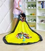 A person is emptying a toy storage bin onto a play mat. Podgląd zdjęcia produktu
