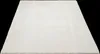A plain white rug is shown from a slightly elevated angle against a black background. Produktbild-Vorschau