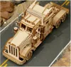 A wooden model of a heavy truck is displayed on a diorama of a road with rocks. Náhľad obrázku produktu