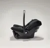 A black baby car seat is shown from the side against a light gray background. Produktbild-Vorschau