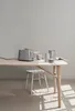 A modern kitchen setting with a toaster, kettle, and cups on a wooden table. Anteprima dell’immagine prodotto