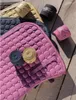 Equestrian saddle pads and wraps are laid out on a wooden surface. Produktbild-Vorschau