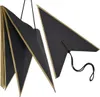 A black, star-shaped decoration with gold trim, hanging by a string. Produktbild-Vorschau