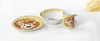 A set of children's tableware with a cartoon lion design. Anteprima dell’immagine prodotto
