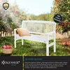 A white garden bench sits in a garden setting with apple trees and a basket of apples. Produktbild-Vorschau