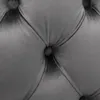 A close-up view of a tufted gray velvet chair cushion. Produktbild-Vorschau