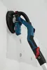 A drywall sander is being used to sand a wall. Podgląd zdjęcia produktu