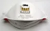 A white 3M Aura respirator mask with a yellow exhalation valve. Produktbild-Vorschau