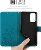 A hand is holding open a teal flip phone case, revealing the black TPU shell inside. Voir les images du produit