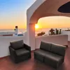 A balcony overlooking the ocean at sunset, with outdoor furniture. Produktbild-Vorschau