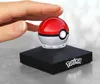 A hand is about to touch a Pokemon Poké Ball replica that is levitating on a black base with the Pokemon logo. Náhľad obrázku produktu