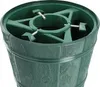 A close-up view of a green Christmas tree stand designed to look like a barrel. Voir les images du produit