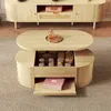 A wooden coffee table with storage is placed on a rug in front of a wooden TV stand. Náhľad obrázku produktu