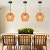 A dining table set with chairs and three pendant lights hanging above. Produktbild-Vorschau