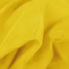 A close-up shot of yellow sheer fabric, showing its texture and folds. Podgląd zdjęcia produktu